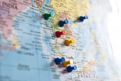 Photo of map with colorful pins marking Southeast Asia countries.