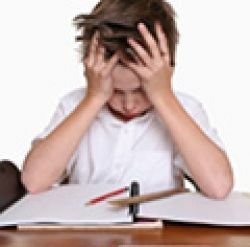 Photo of child stressed while doing homework.