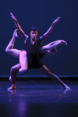 Photo of two dancers, one supporting the other.
