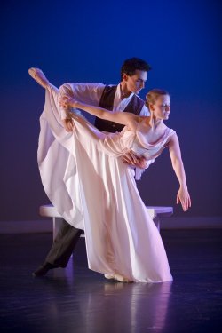 Photo of male and female dancers in flowing clothes.