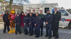 Picture of EMS members and Dr. Susan A. Cole in front of a new ambulance dedicated in the fall '17 semester.