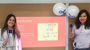 Image of two people standing in front of a projected image.