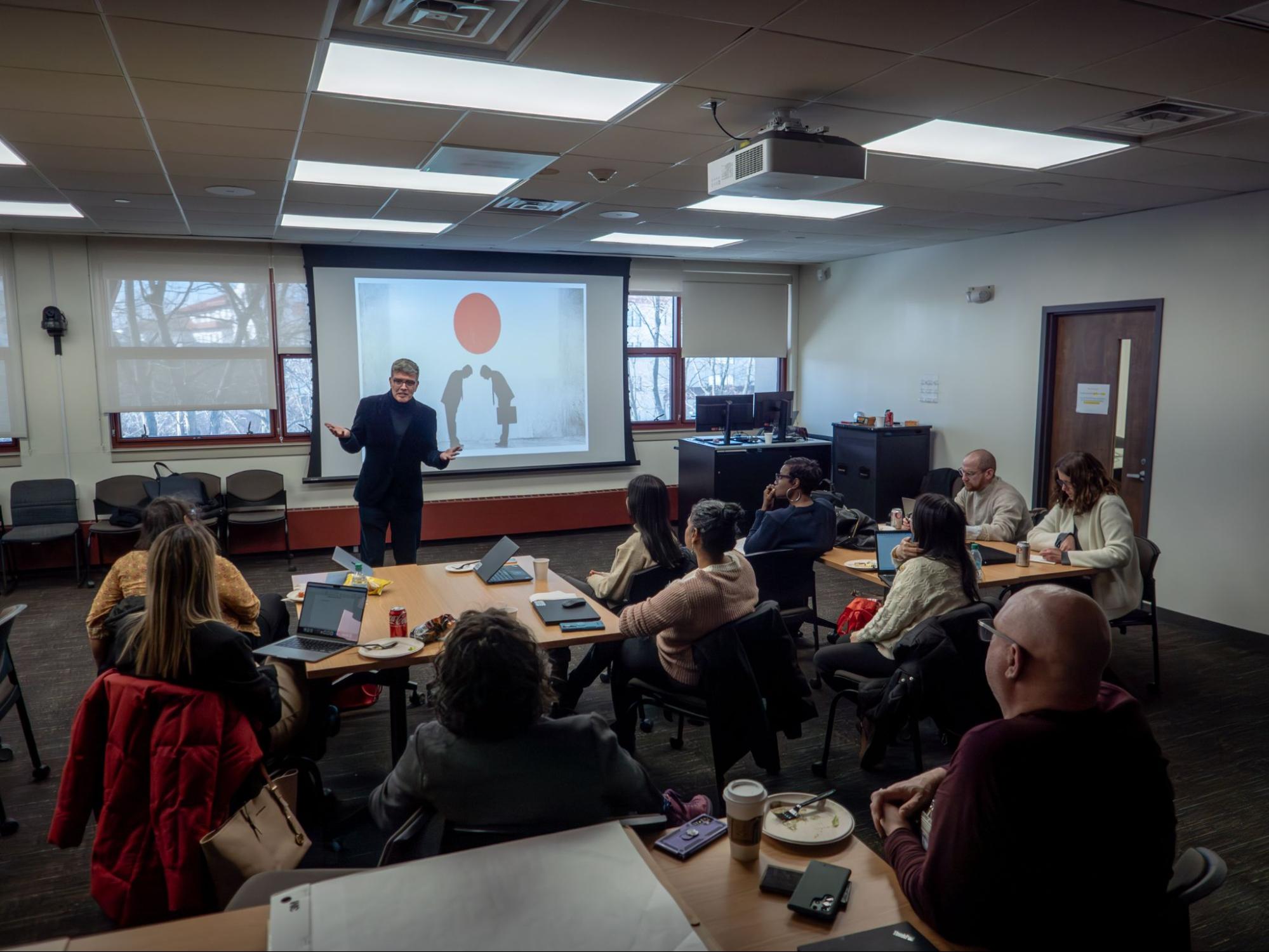 Speaker giving a presentation to a group of people.