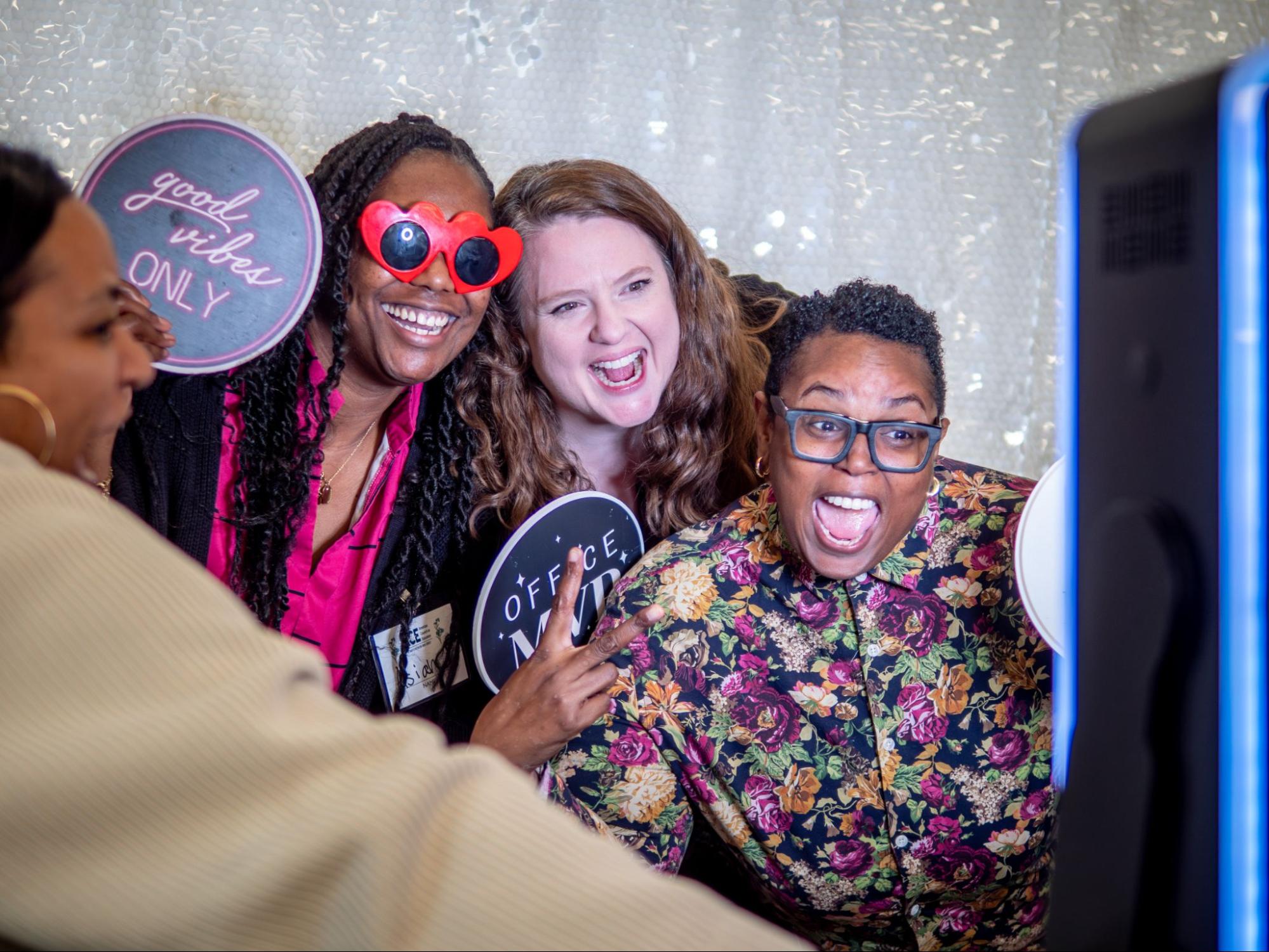 Three women taking a photo together.