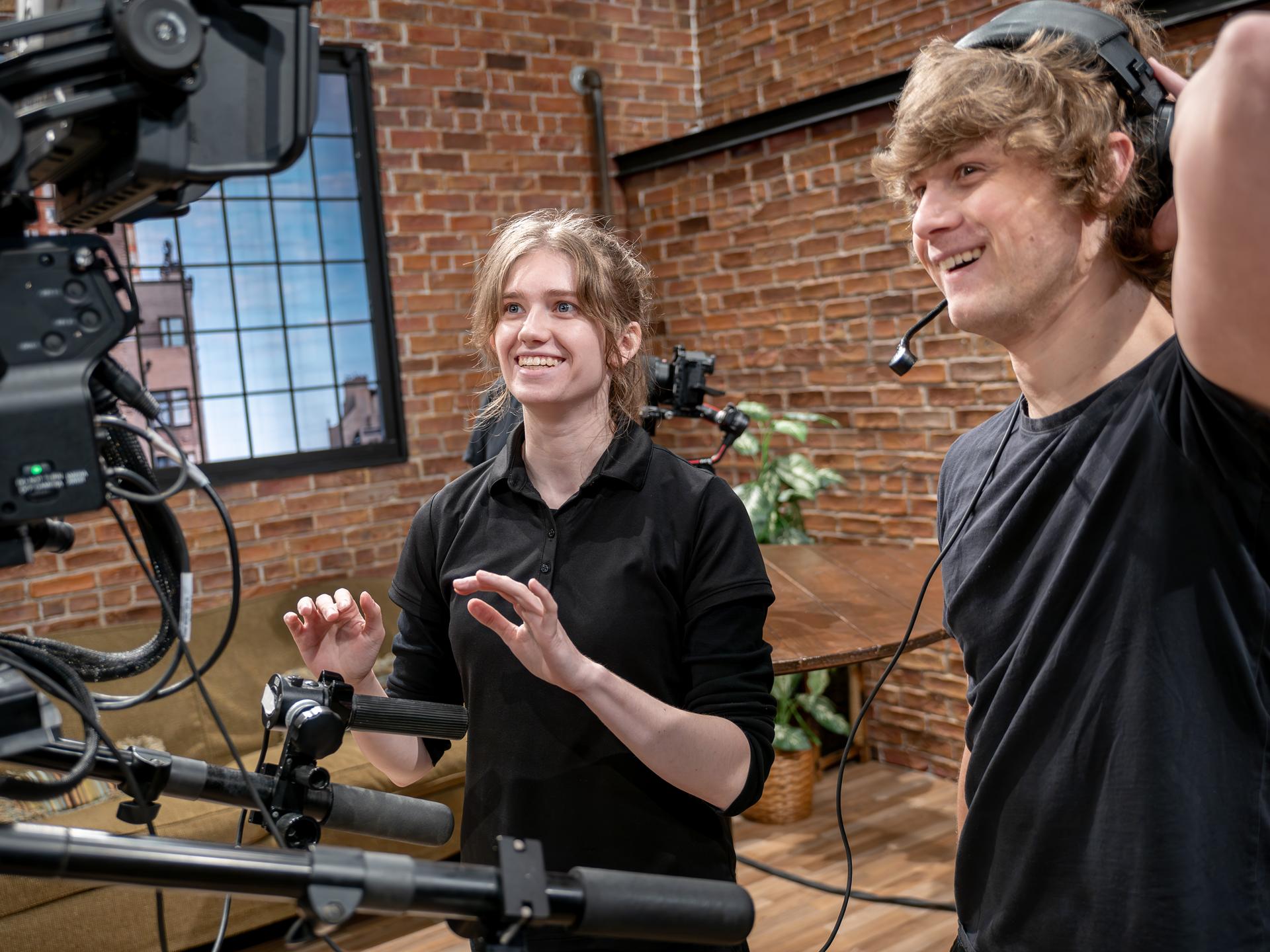 Two people working on the set of Cooking with Koppell