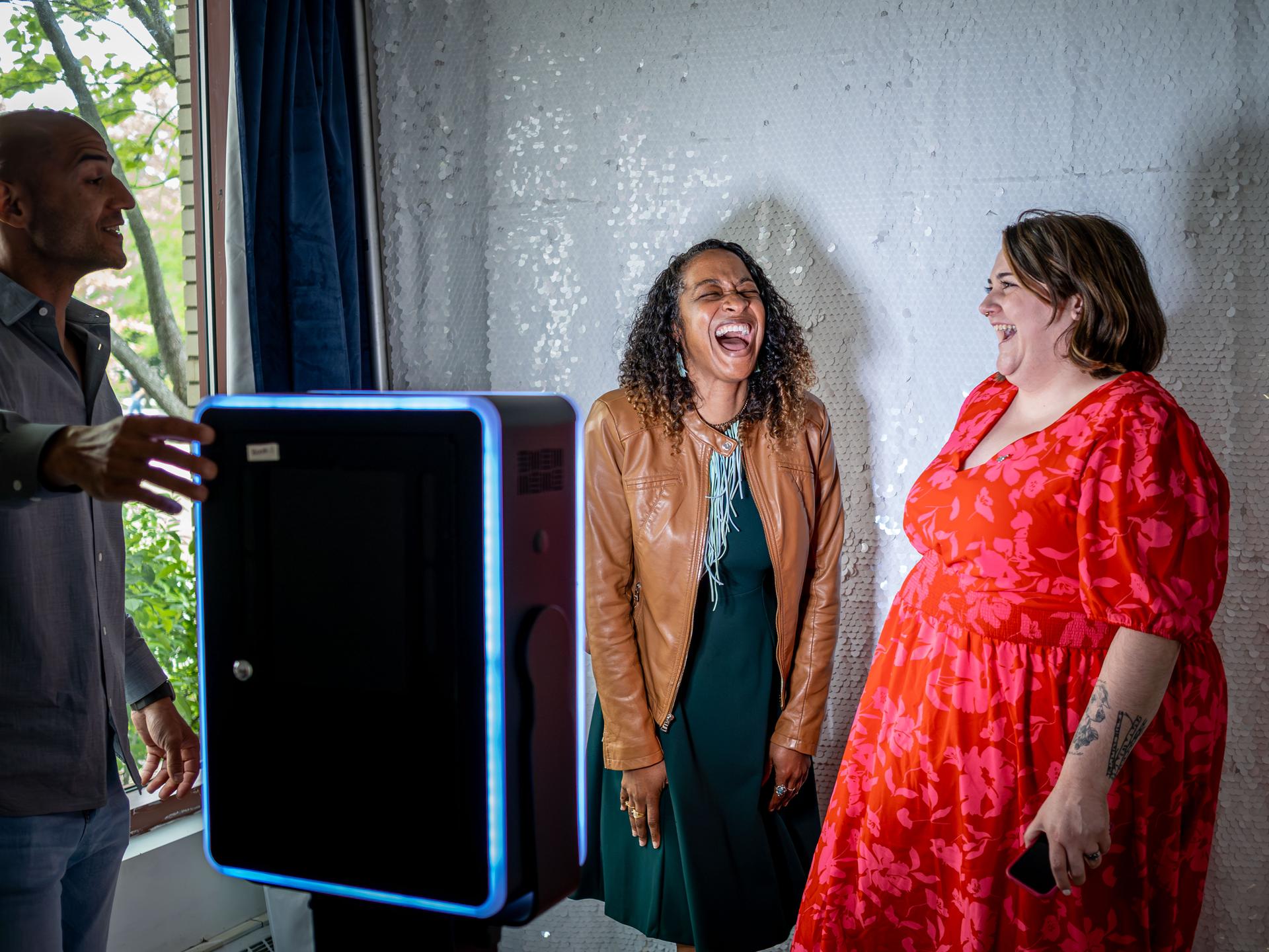 University employees taking a photo at a photo booth