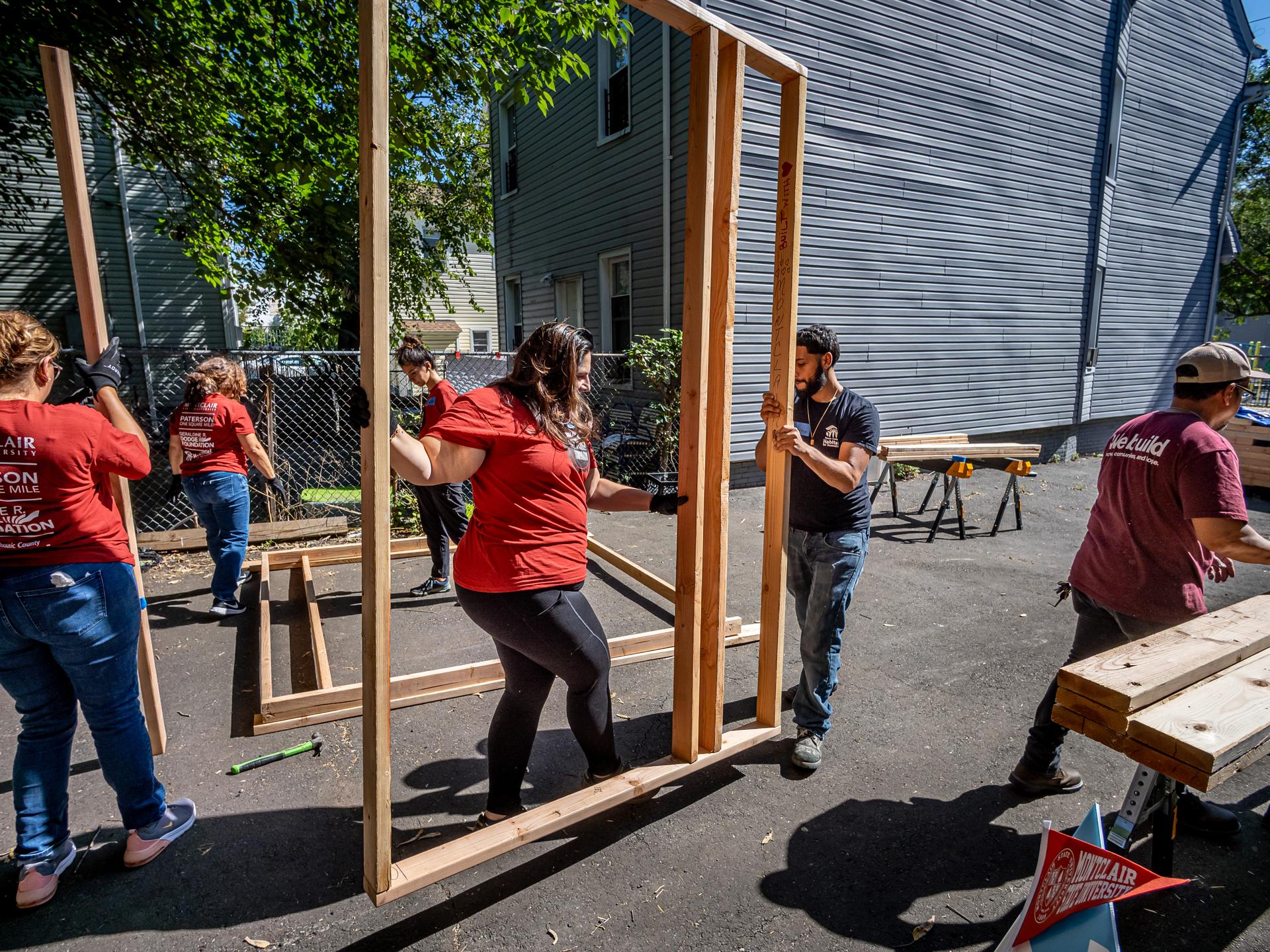 People lifting wood frames