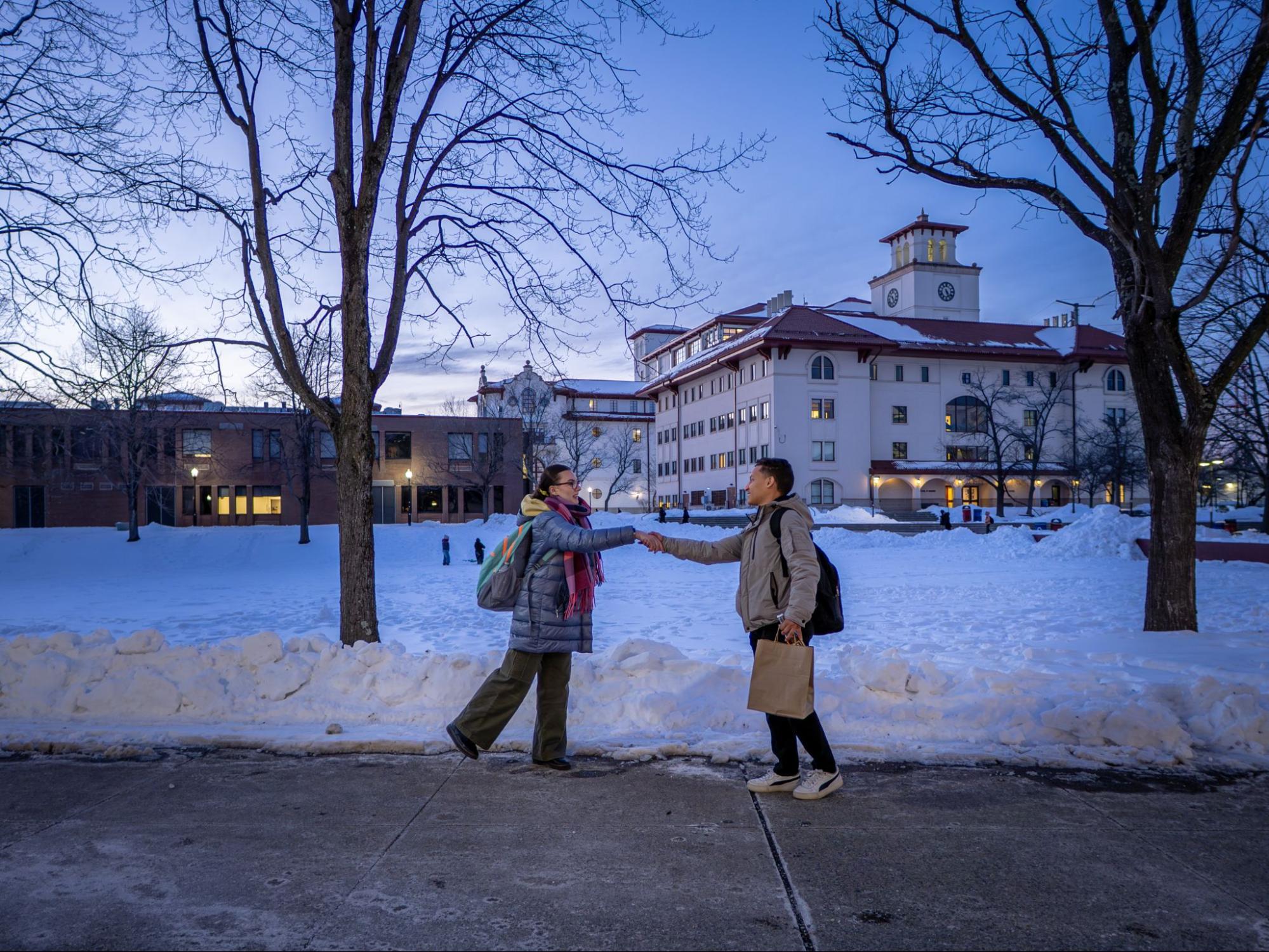 A photo of a two students shaking hands on Montclair's Campus.