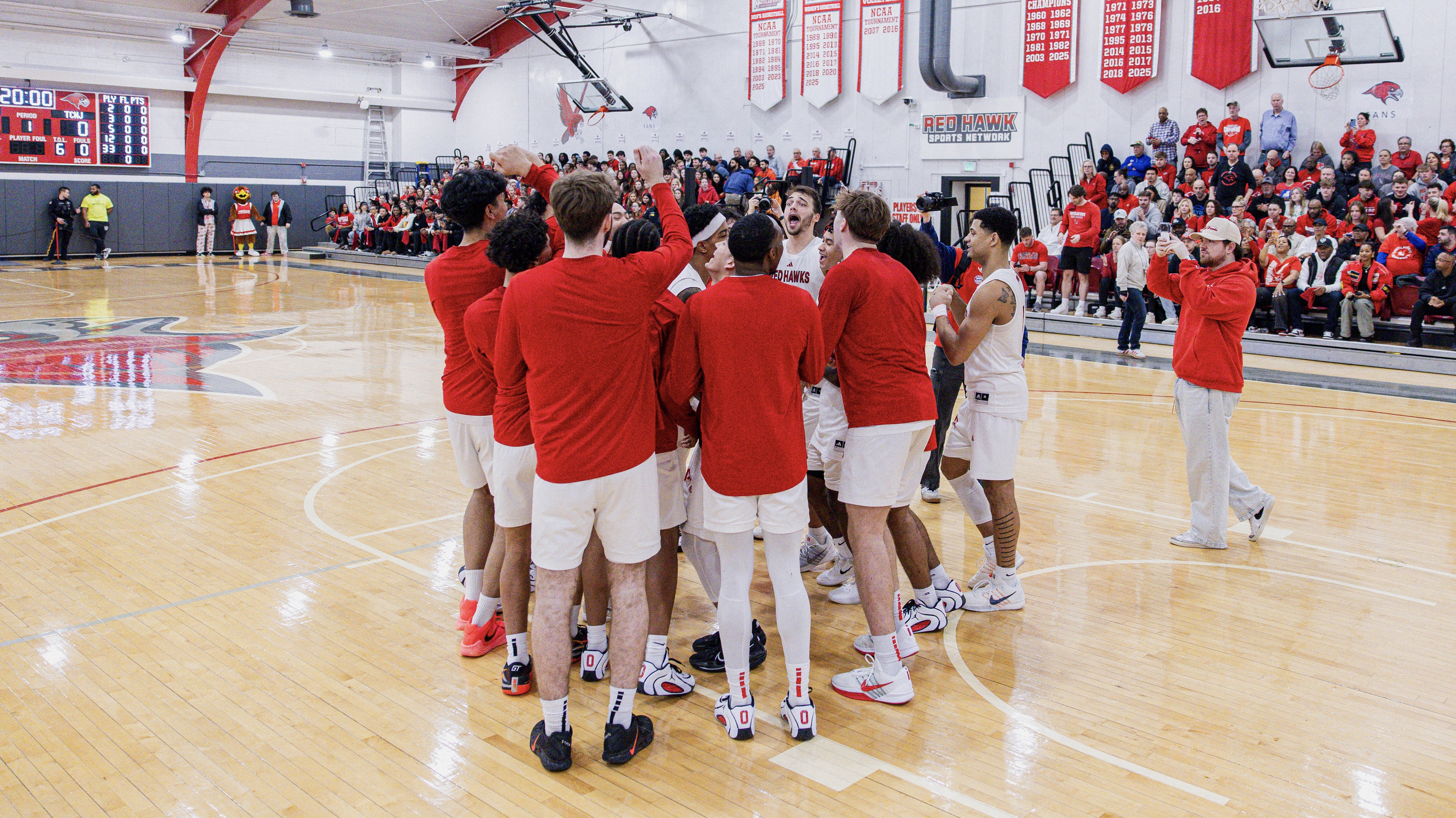 The ����vlog men’s basketball team gathers together before a game at the Panzer Athletic Center.