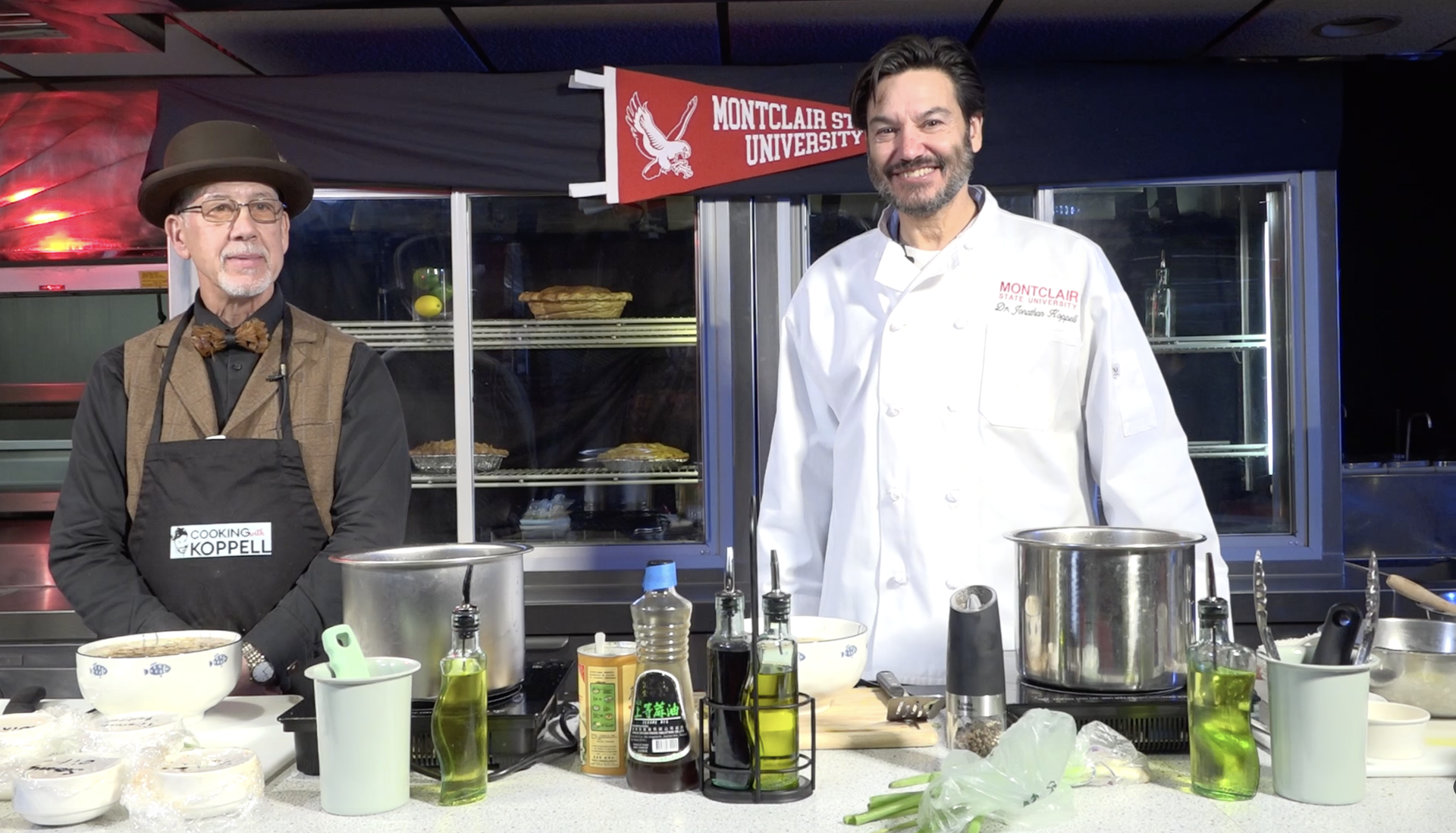 President Koppell and Tom Ormond posing for a photo on the set of Cooking with Koppell.