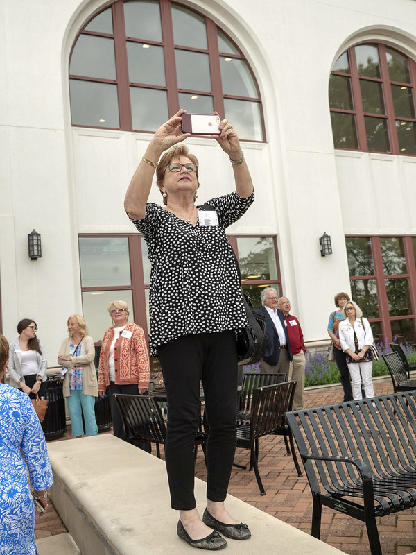 Woman takes a photo during the campus tour