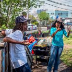 Winter Sims, the farm’s program coordinator, gesturing thumbs up to Montclair students during a tour with farm manager Christian Rodriguez at Down Bottom Farms.