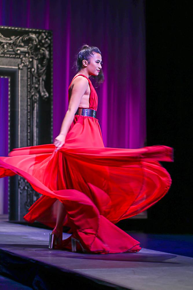 woman in red dress twirling