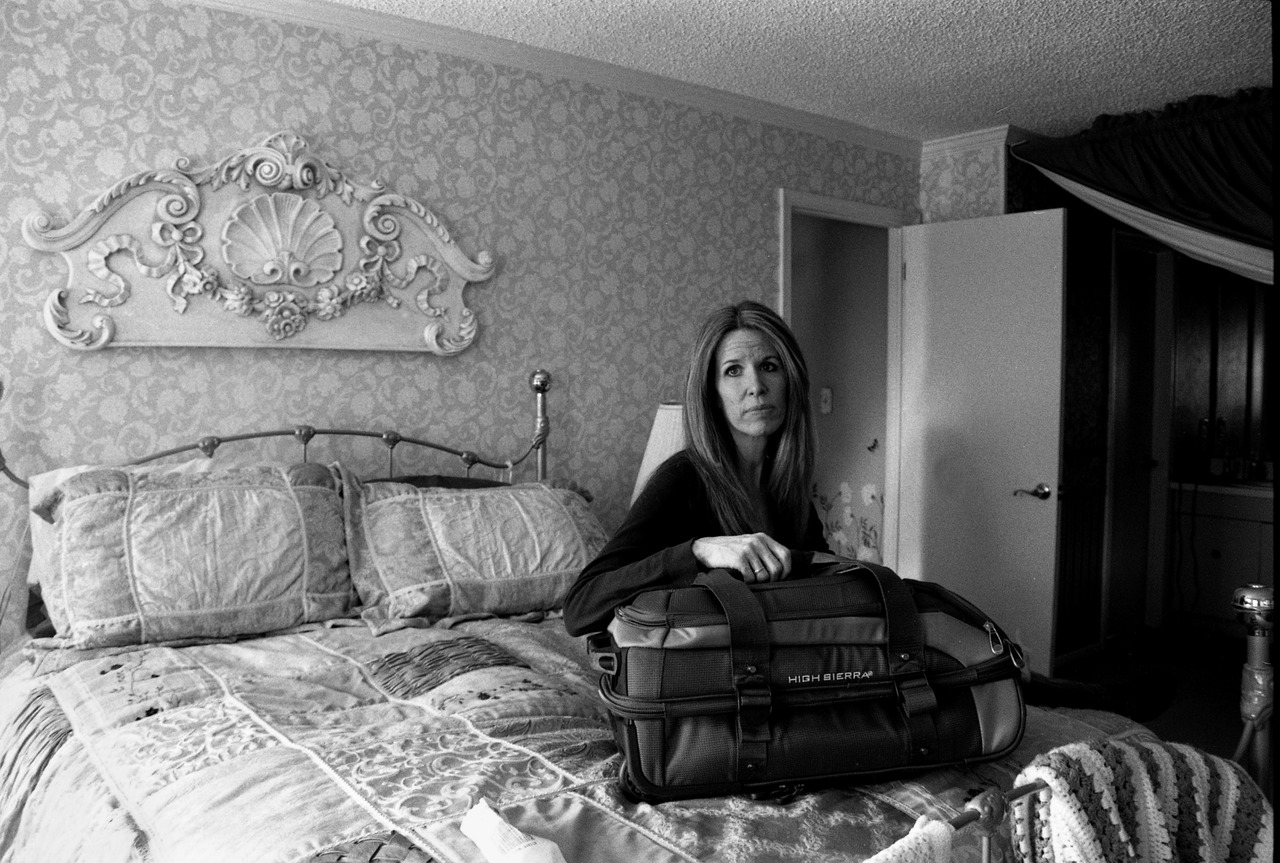 woman sitting on bed