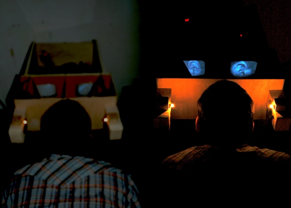 people looking at images through box