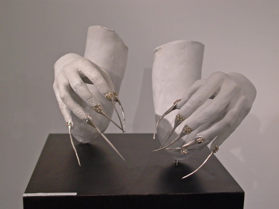 sculpture of hands with spiky fingernails