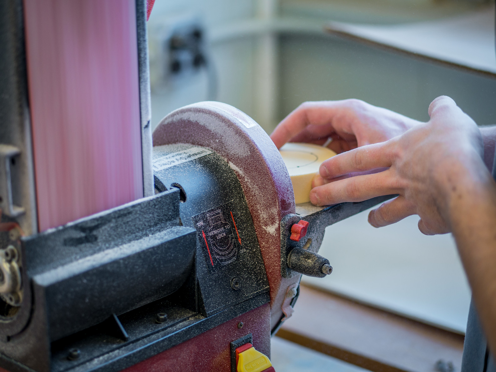 student using disc sander on product design project