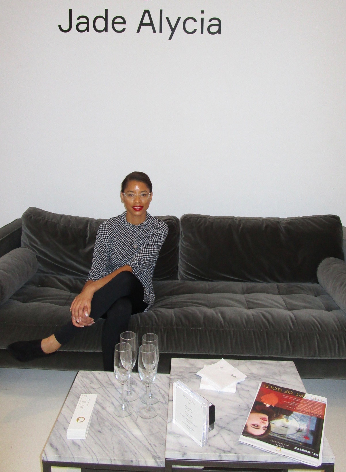 Jade Alycia posing on suede couch in her Showroom