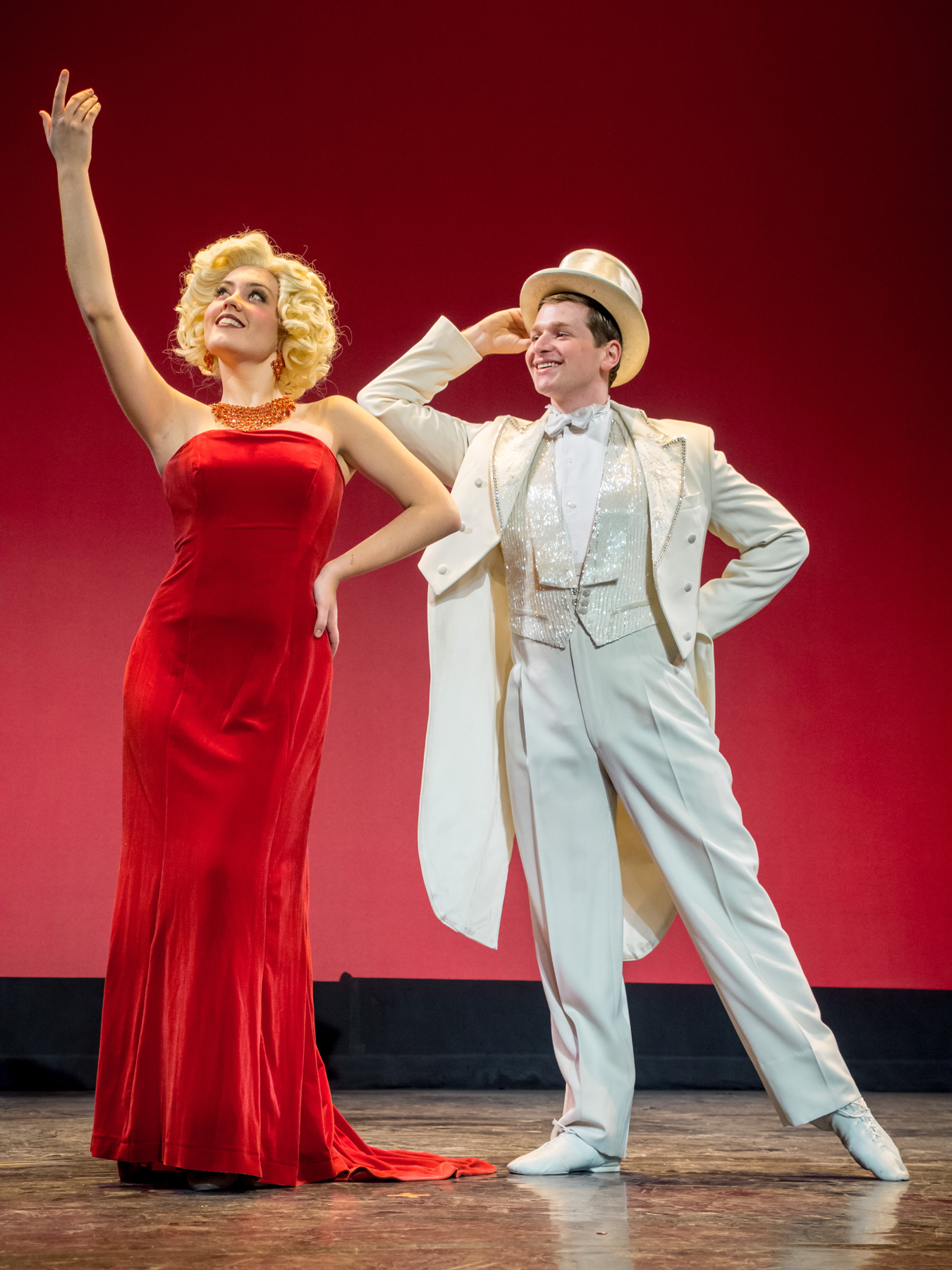 Woman in red dress and man in white suit