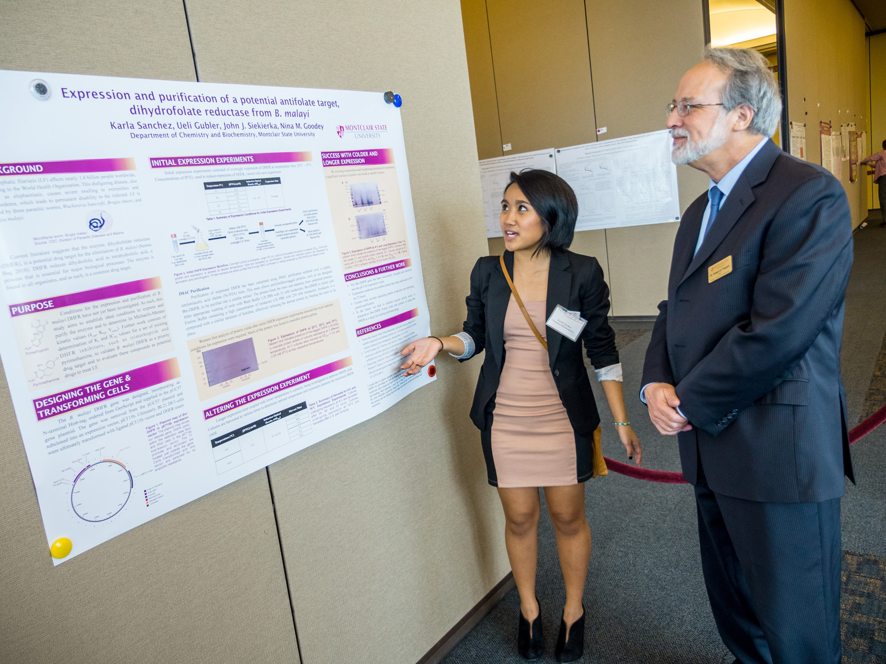College of Science and Mathematics Dean Robert Prezant listens to Karla Sanchez explain her work.