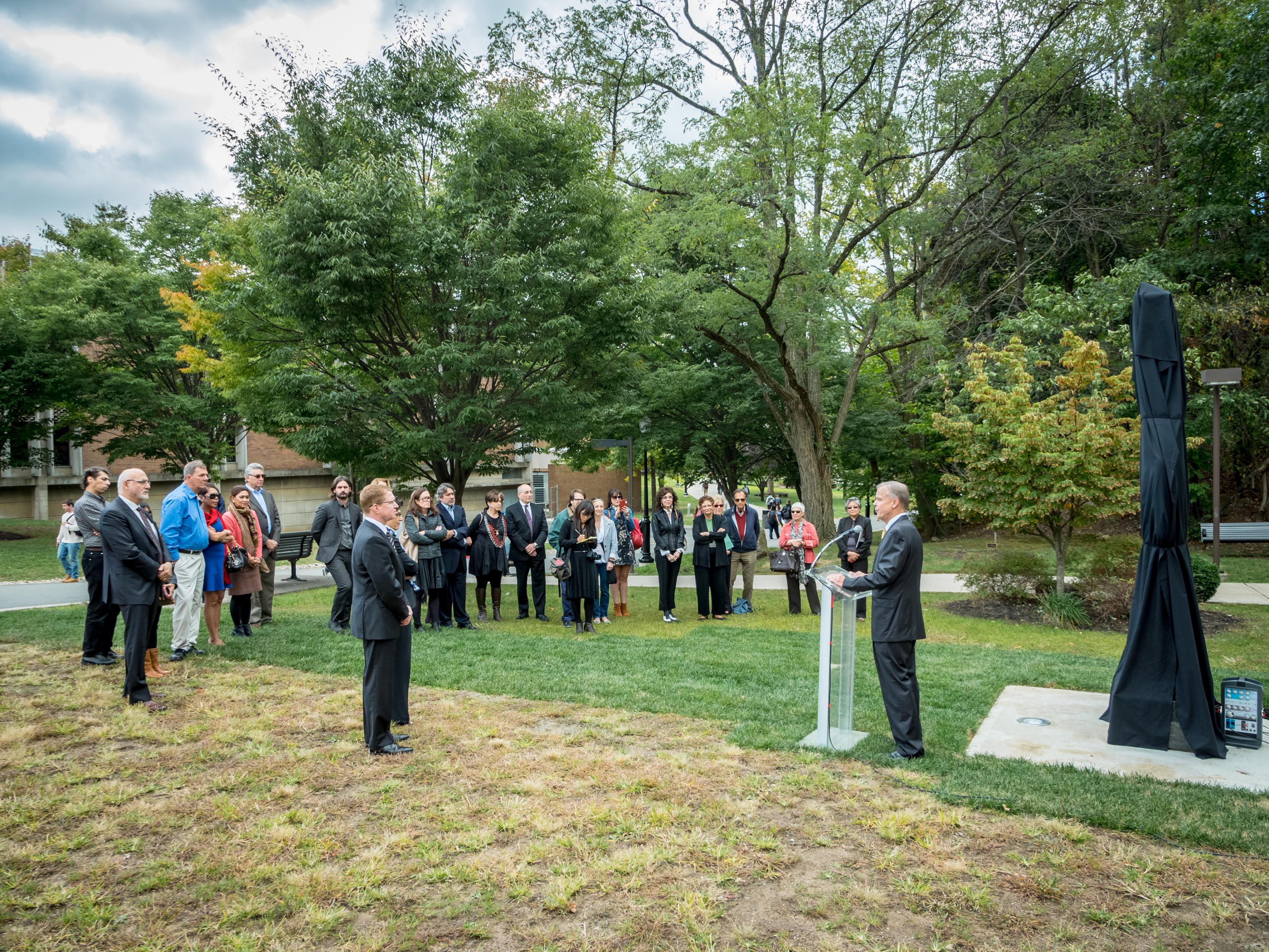 Dean Daniel Gurskis addressing the audience at the "Secret Totem" dedication.