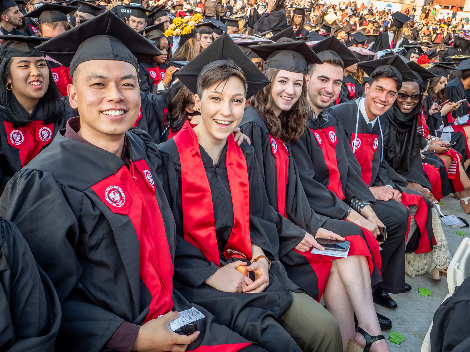 students in caps and gowns sitting together