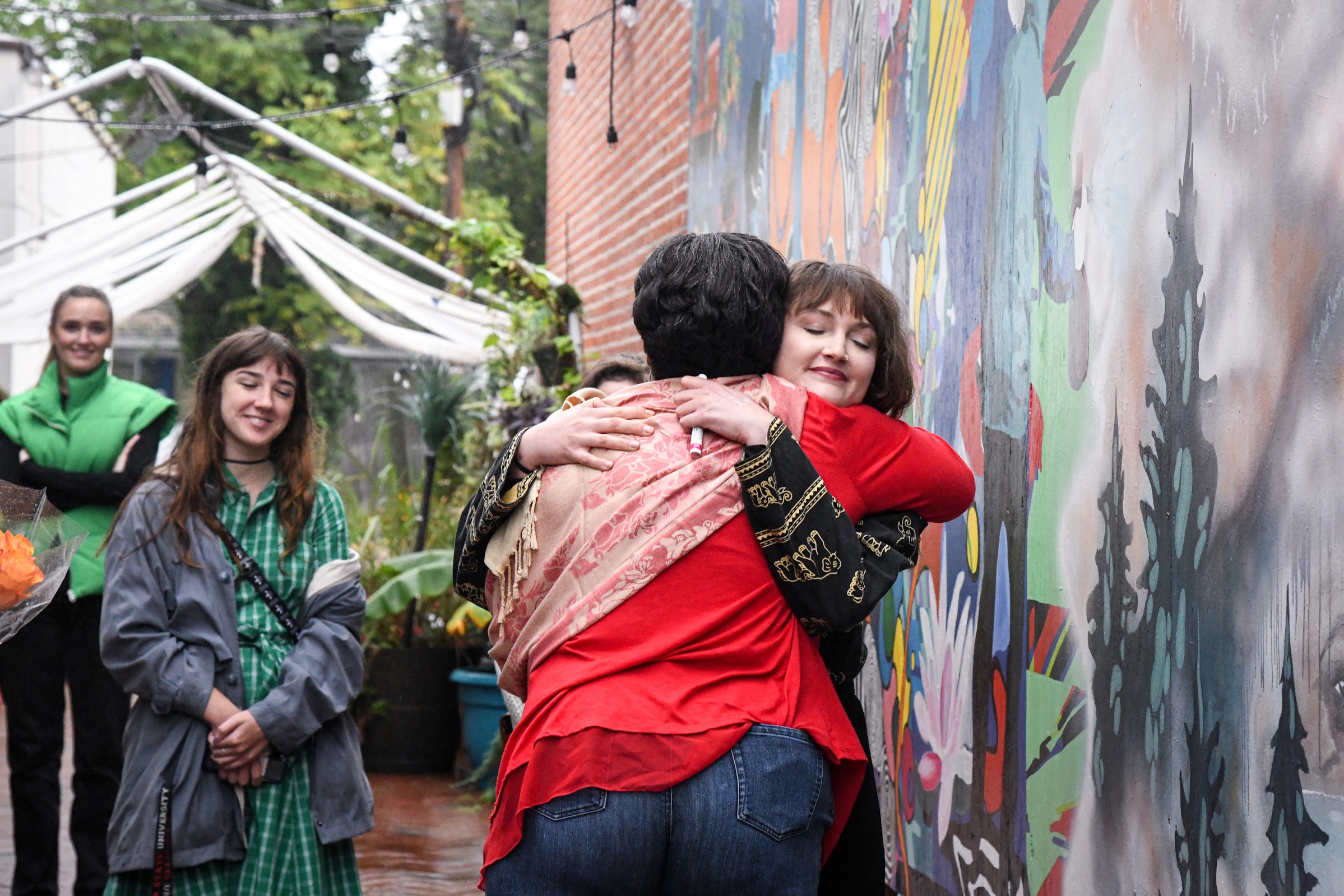 Artist Lauren Vroegindewey hugs Norma Tassy