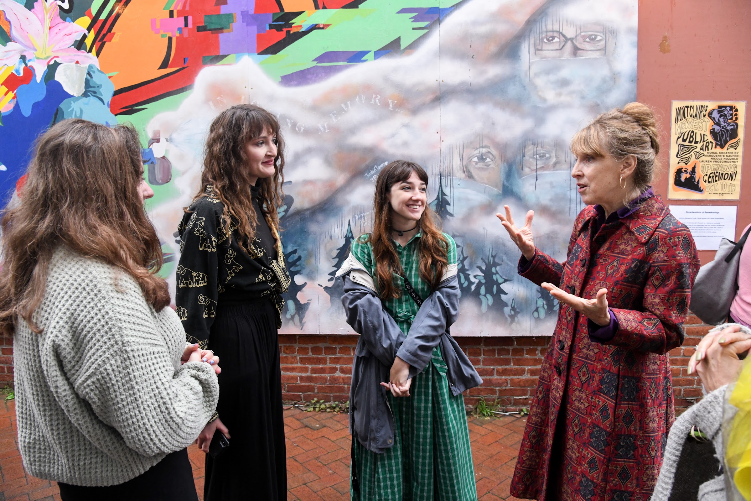 Julie Heffernan, right, speaks with her student muralists, from left, Marguerite Kaufer, Lauren Vroegindewey and Nicole Nuzzolo