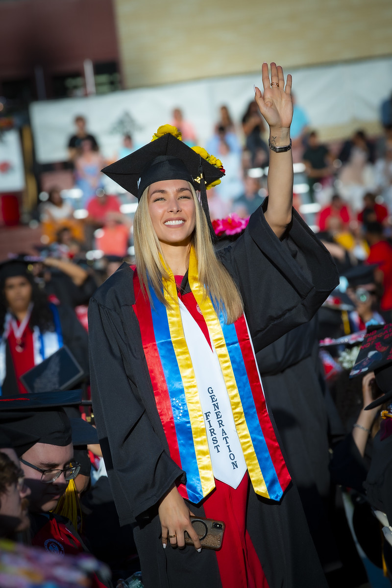 young woman waving from crowd