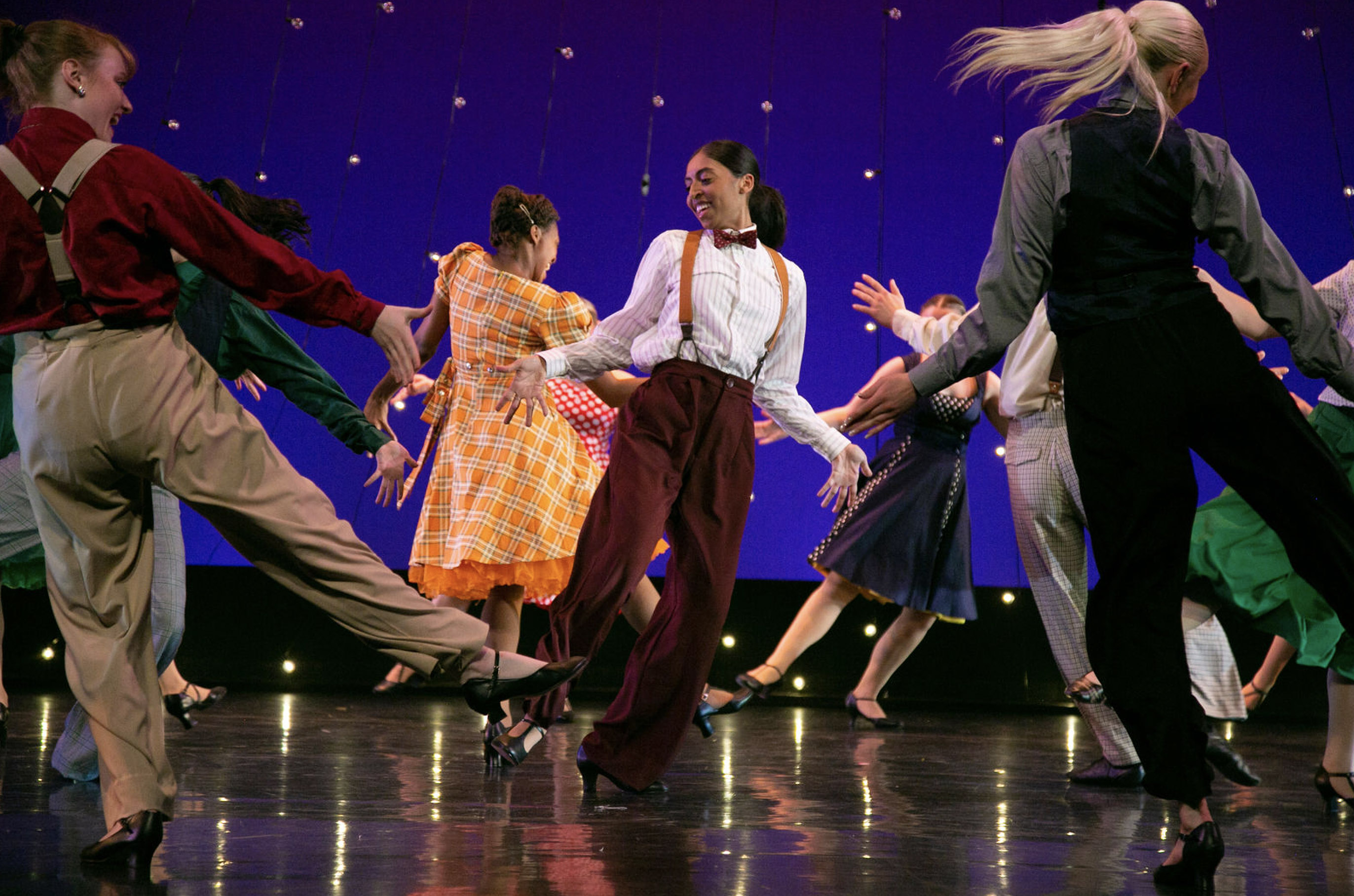 Image of students dancing on stage, promoting Spring Dance 2023