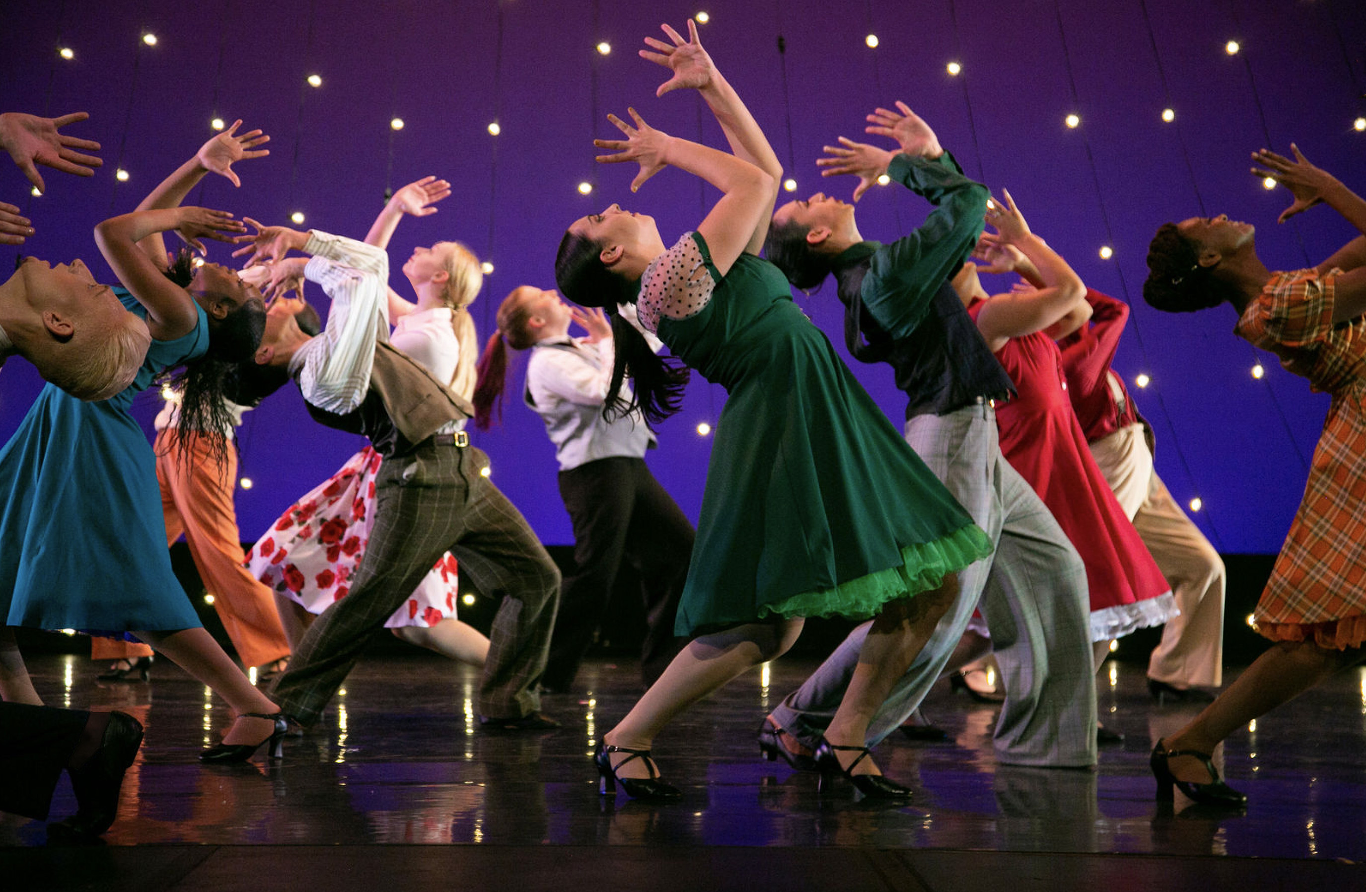 Image of students dancing on stage, promoting Spring Dance 2023