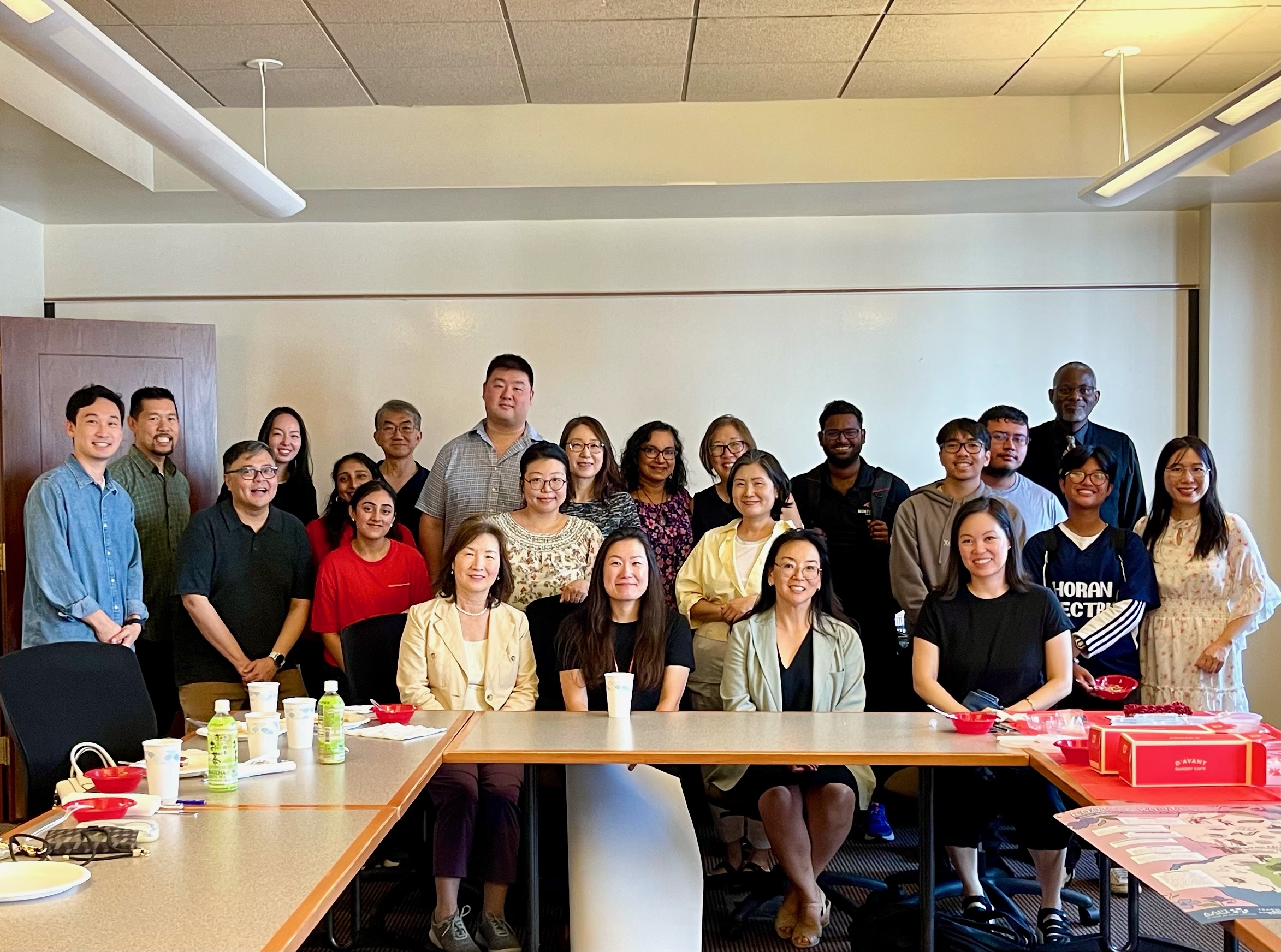 APIC members gather around a table and smile