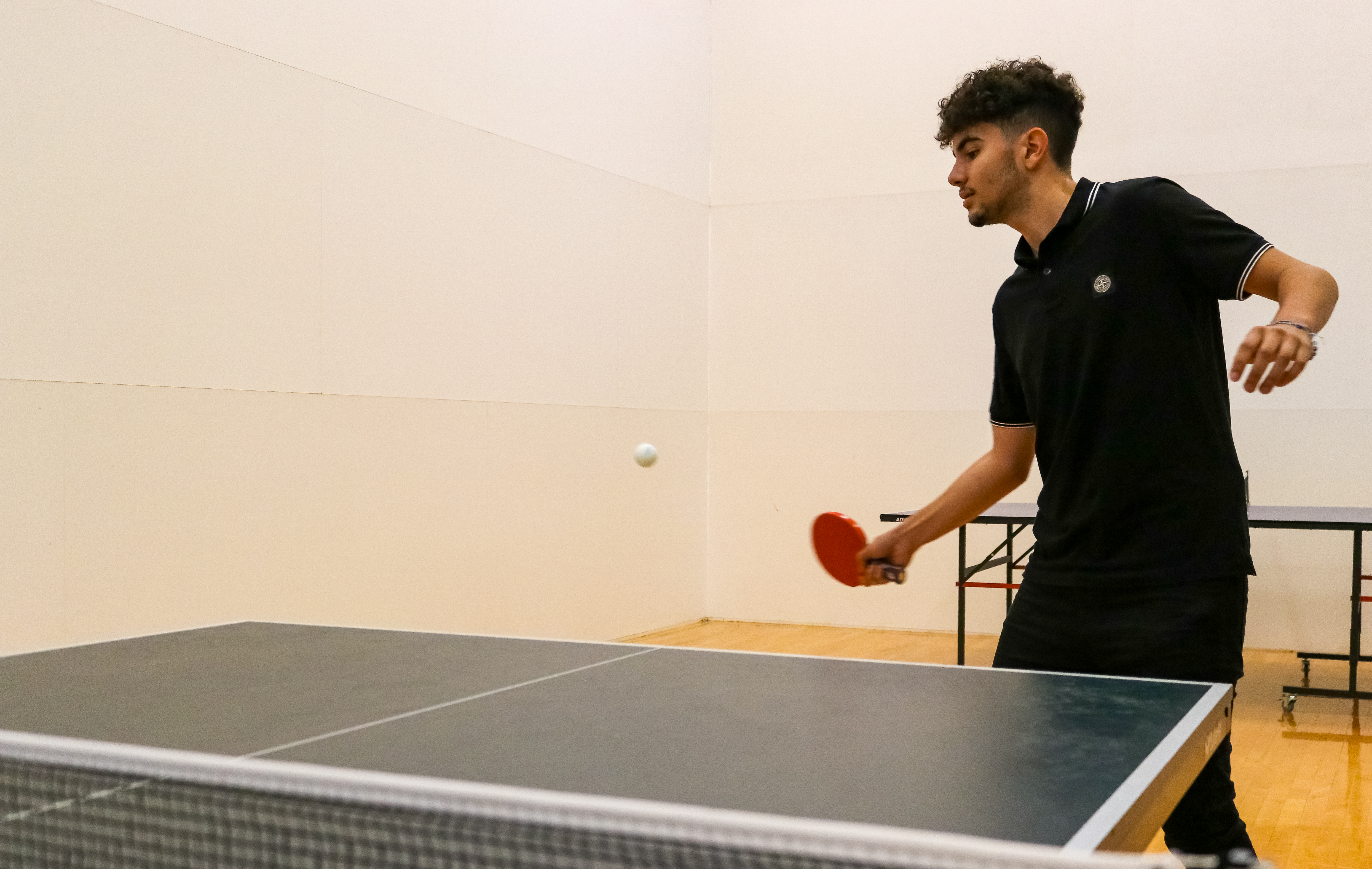 Two Montclair State club table tennis players practicing