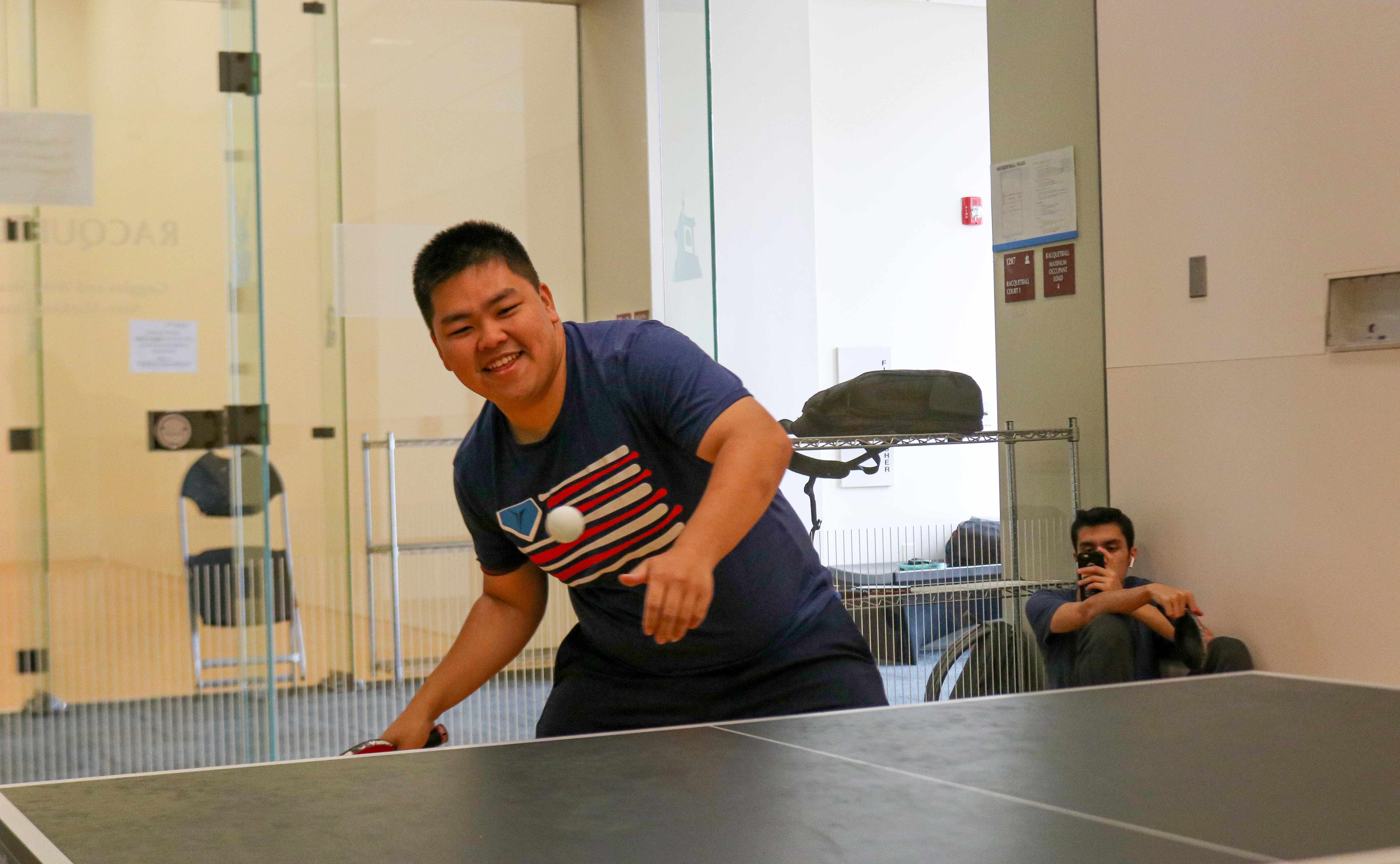 Two Montclair State club table tennis players practicing