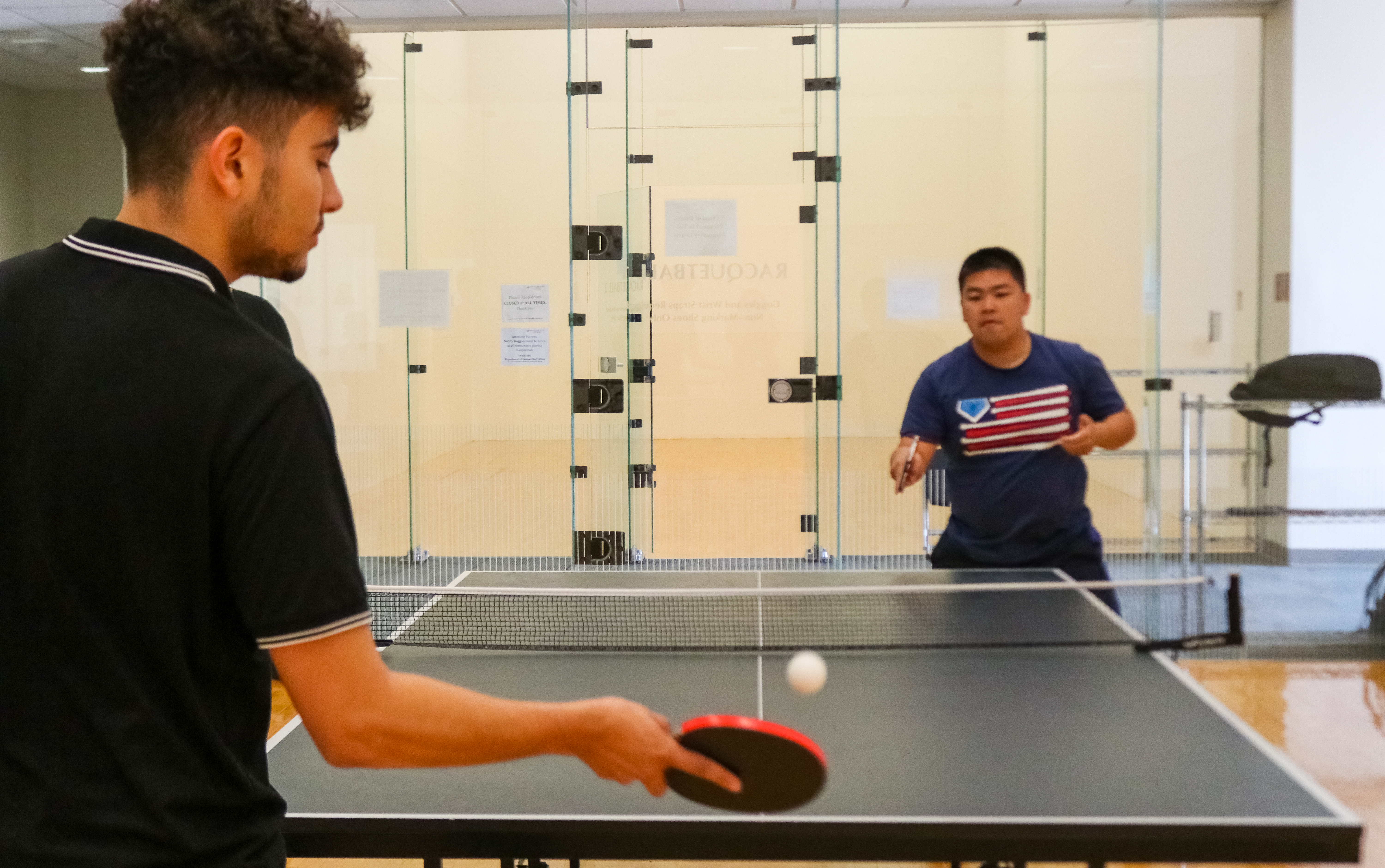 Two Montclair State club table tennis players practicing