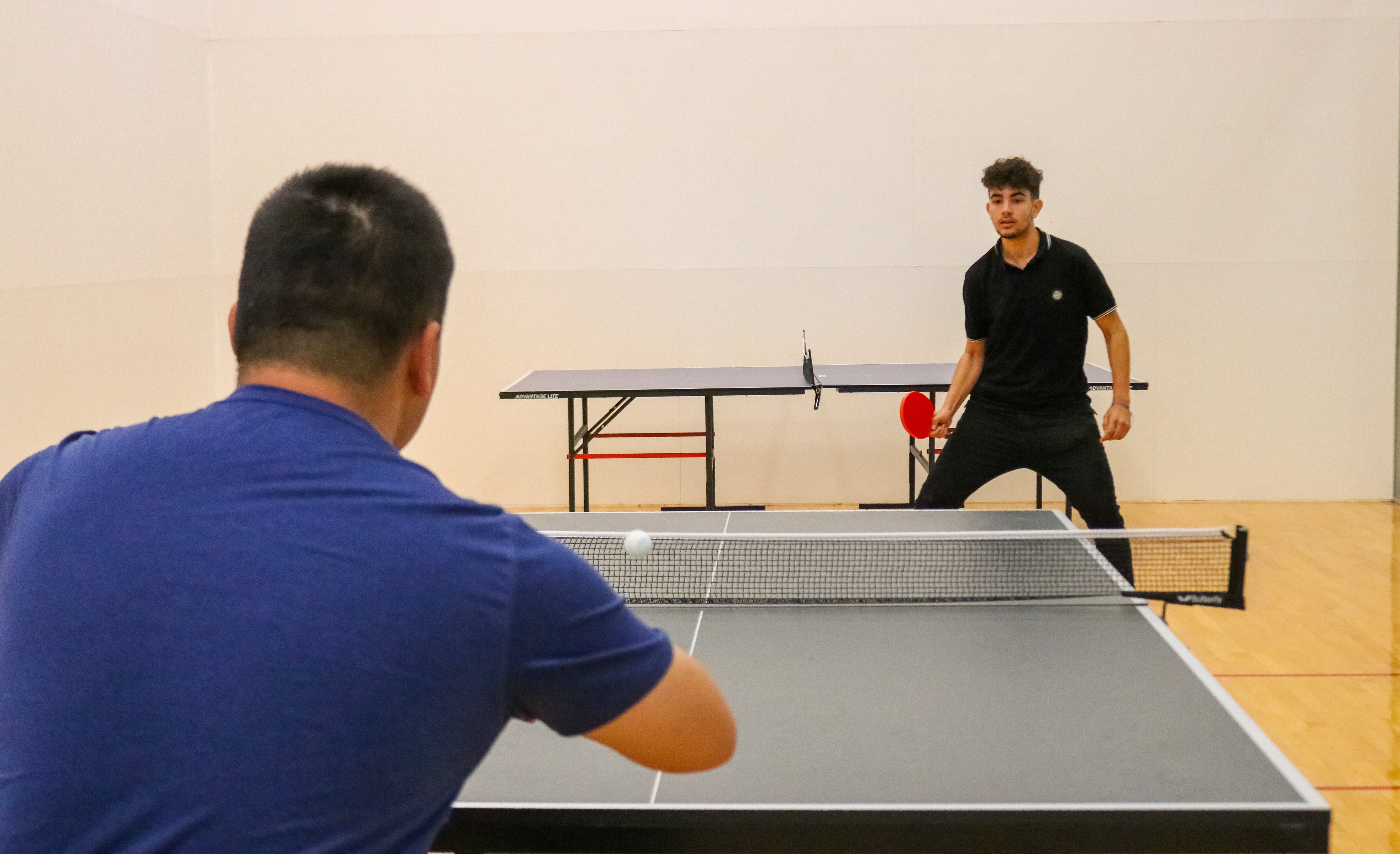Two Montclair State club table tennis players practicing