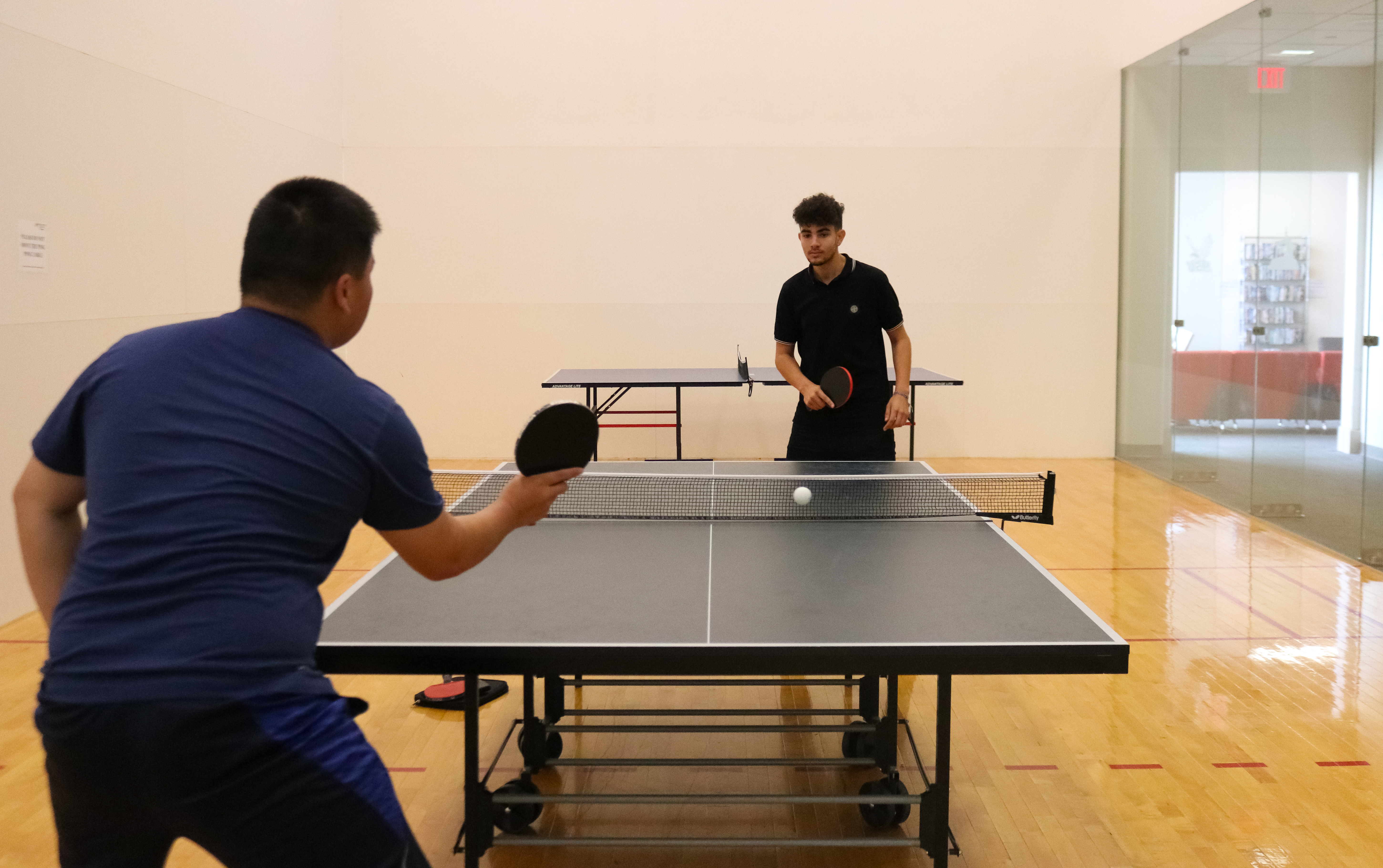 Two Montclair State club table tennis players practicing
