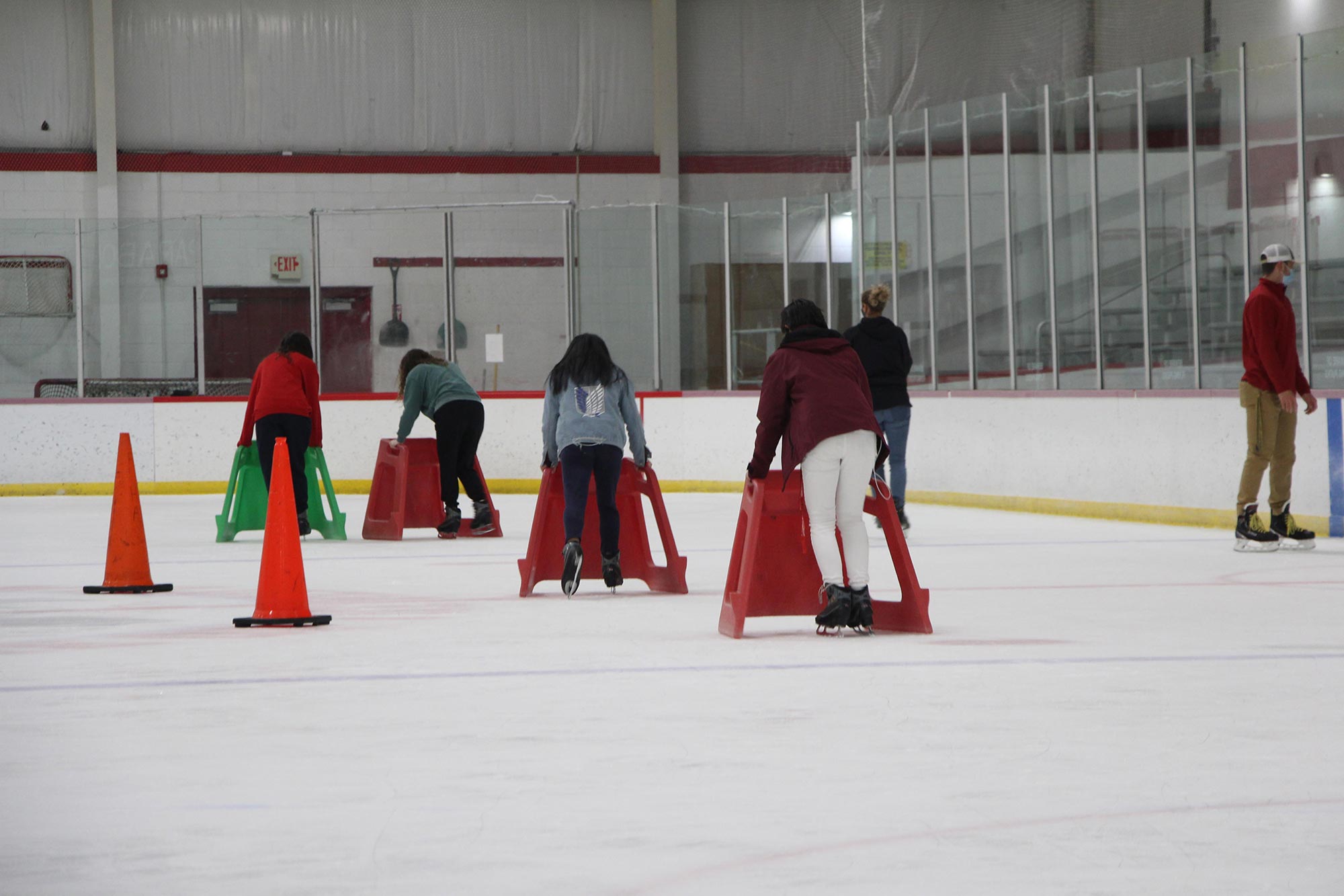 A photo of beginner ice skaters learning to skate.