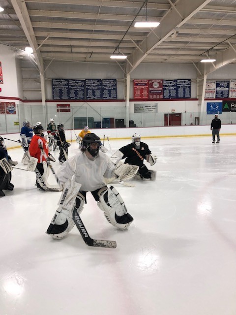 A photo of hockey goalies practicing at the ice rink inside the Montclair State University Ice Arena.