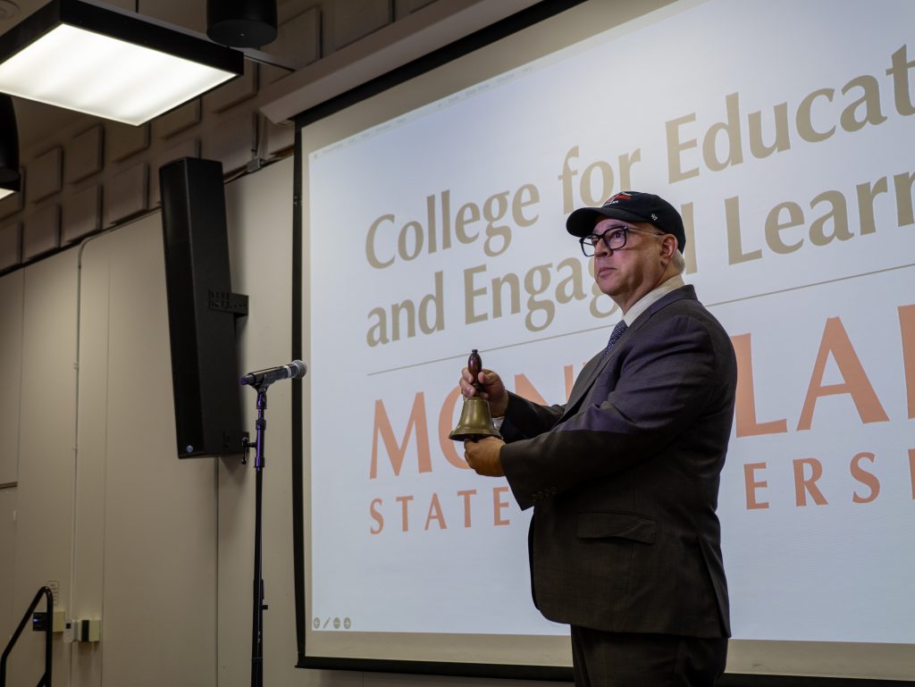 Interim Dean Vincent C. Alfonso ceremoniously ringing the school bell