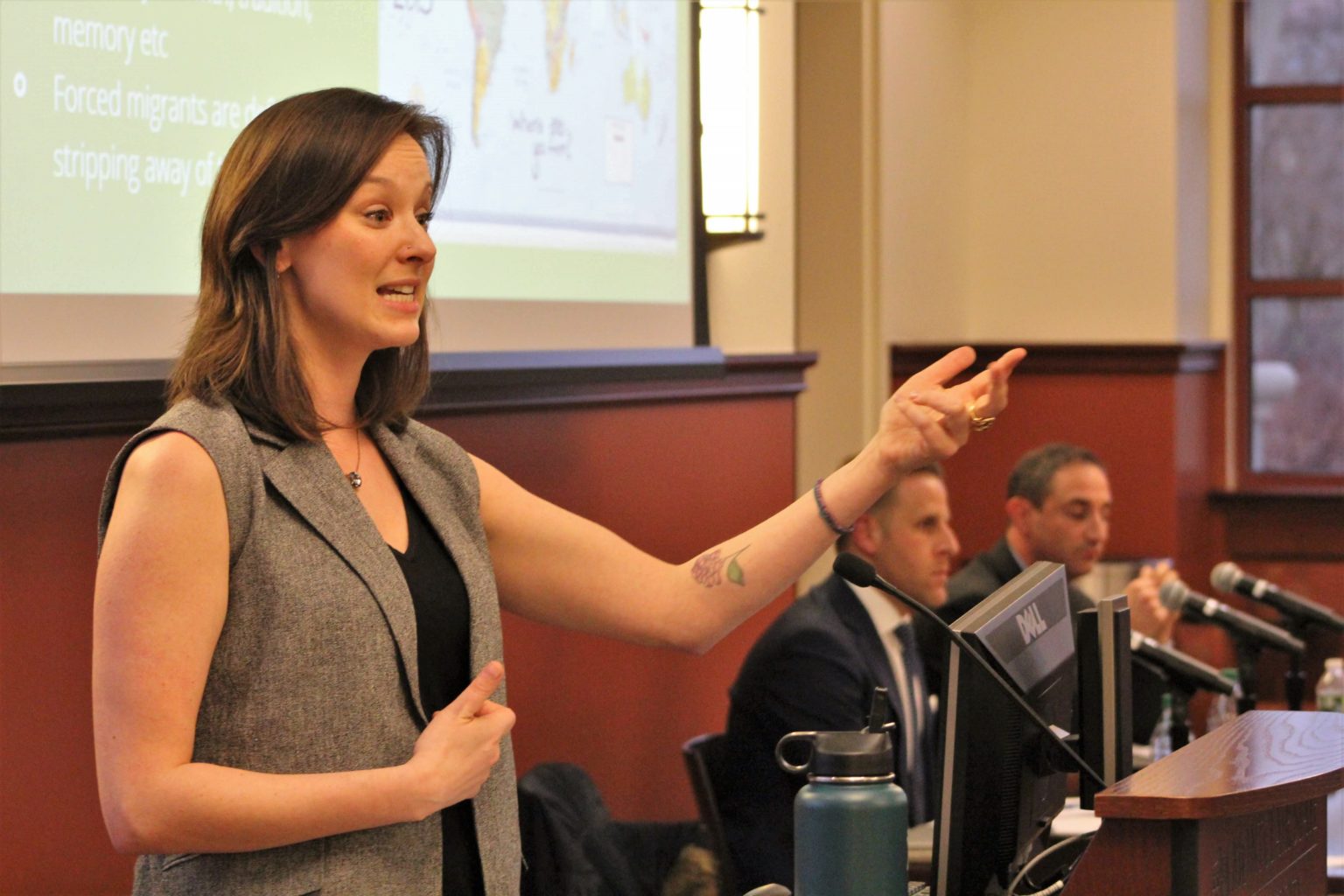Panelist Kira O’Brien gives a presentation on forced migration at the immigration symposium.