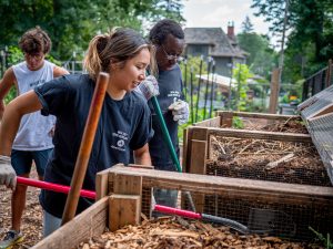 Student volunteers in front of composters