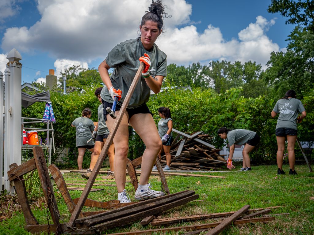 Young women deconstructing and old bench