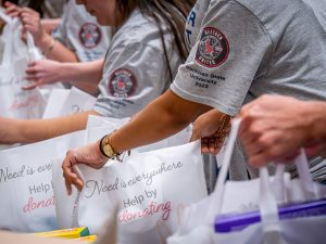 NextGen Students pack grocery bags for local food pantry