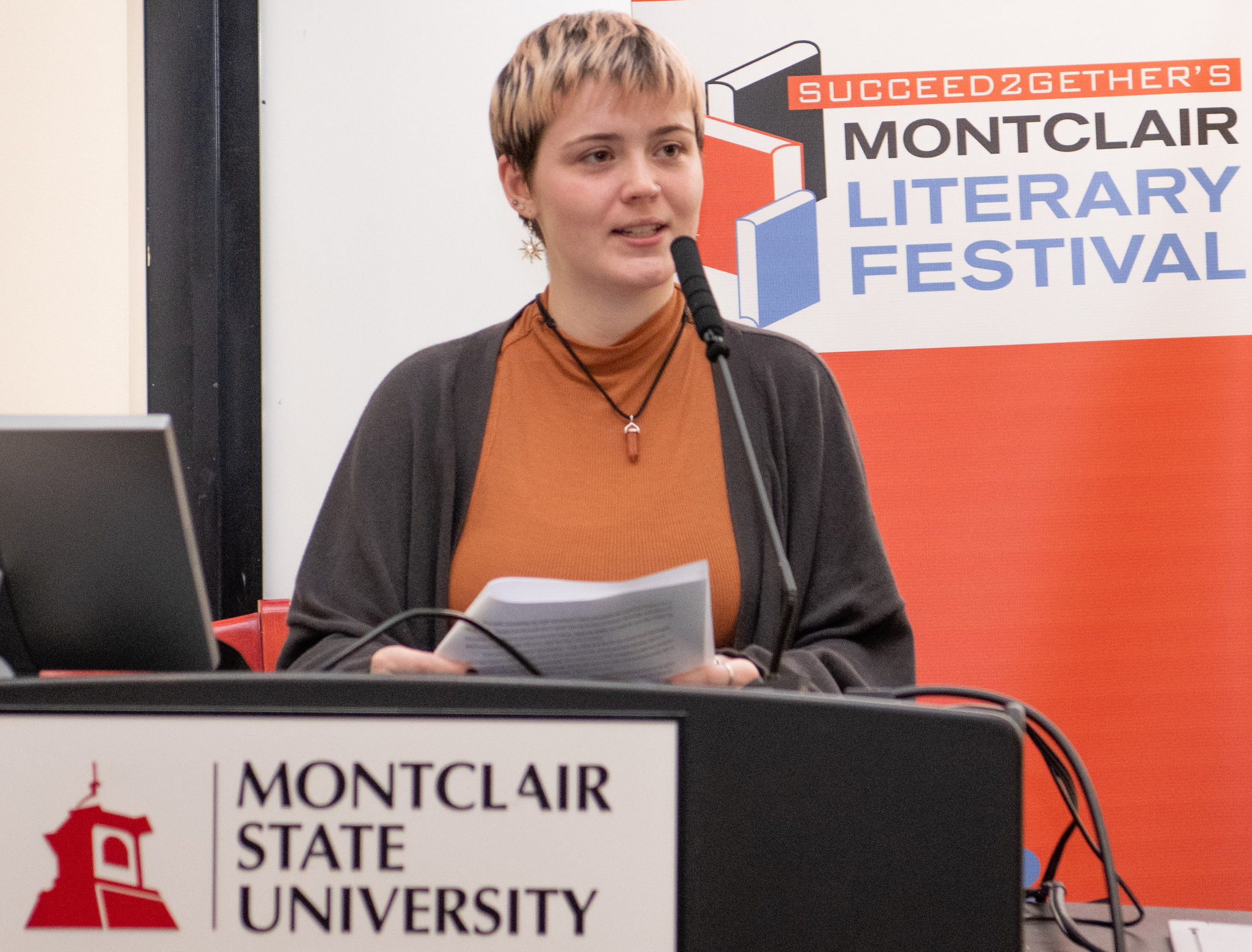 Emily Paluba speaking at a podium