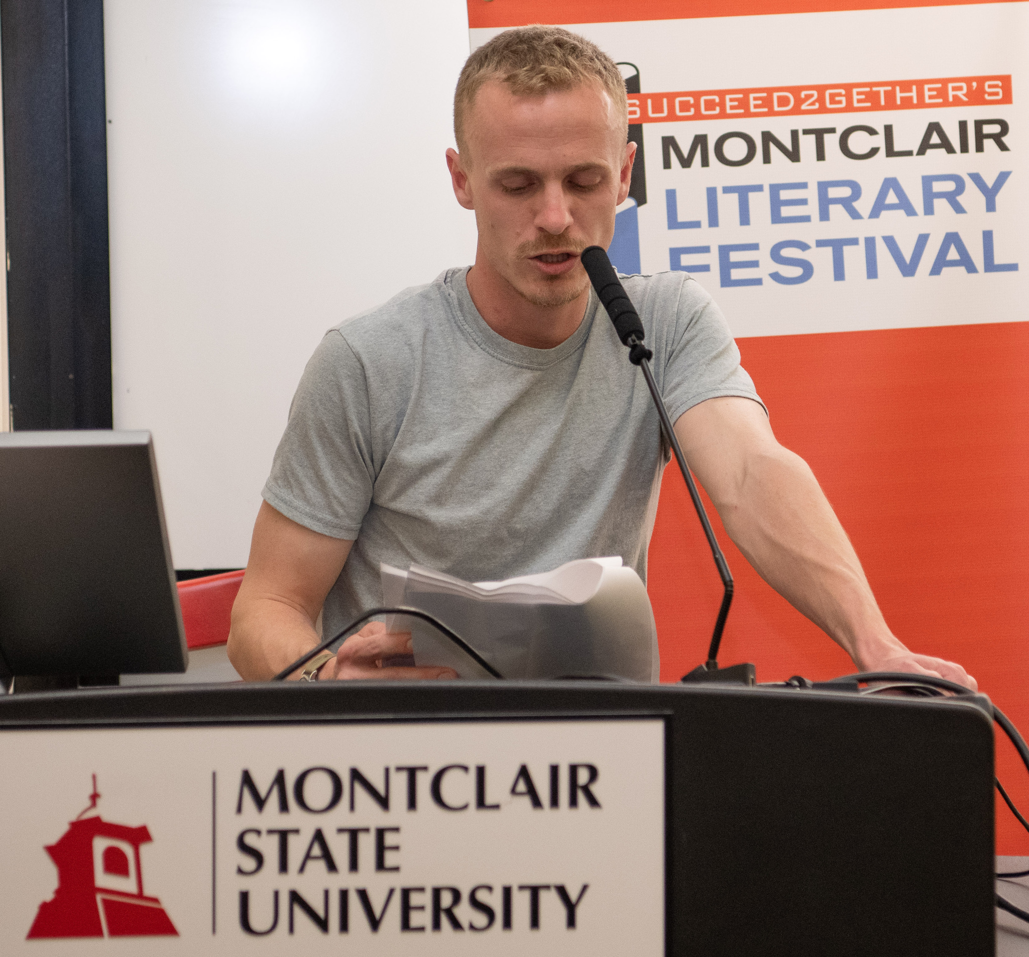 student Justin Dietz speaking at a podium