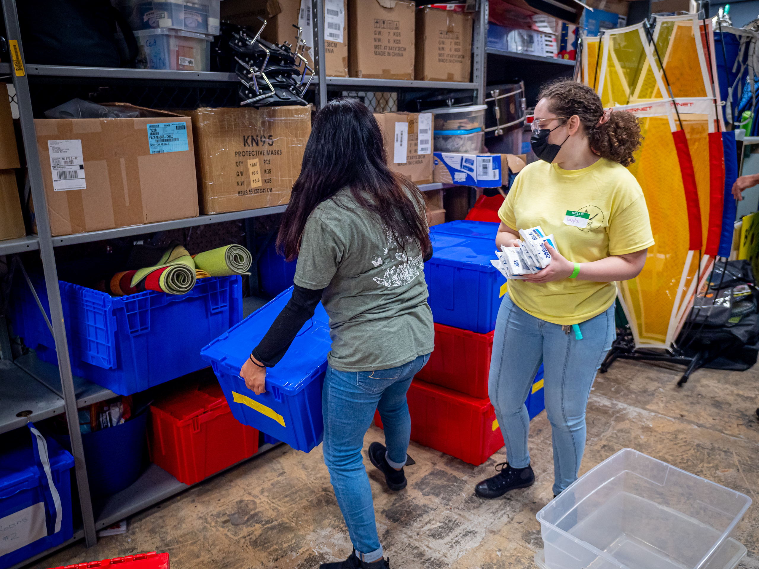 Volunteers organize sports equipment at the Boys & Girls Club, Clifton