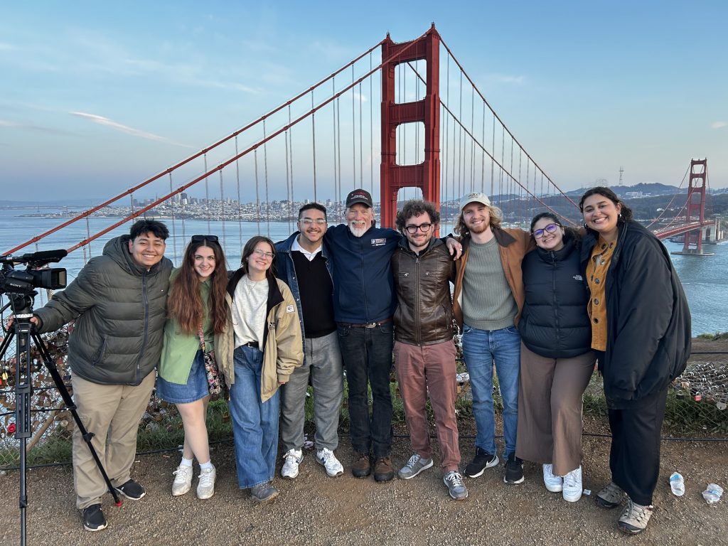 Students in the field posing in front of the Golden Gate bridge in San Francisco
