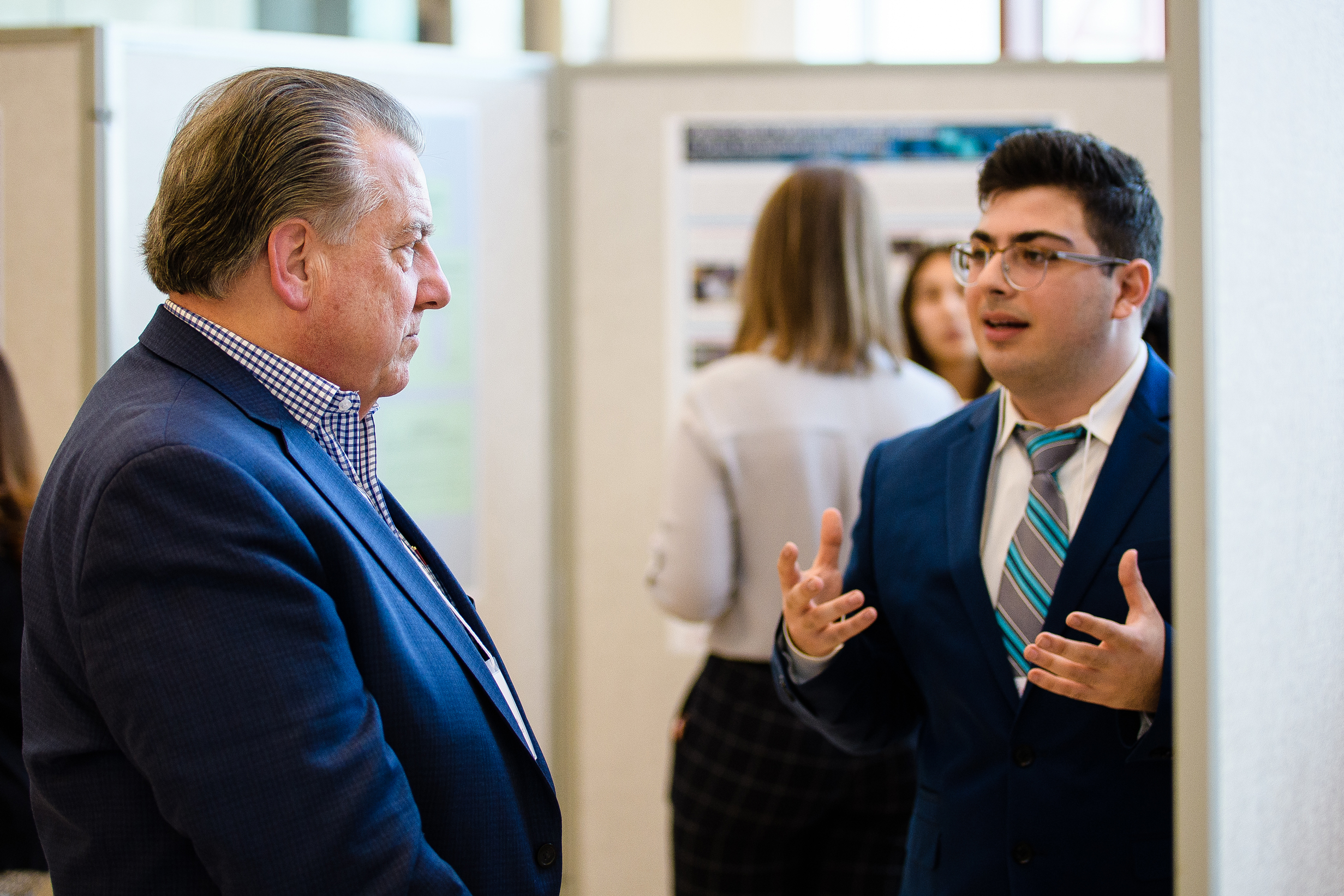 Gerard Nasser explaining his poster to Mario Casabona