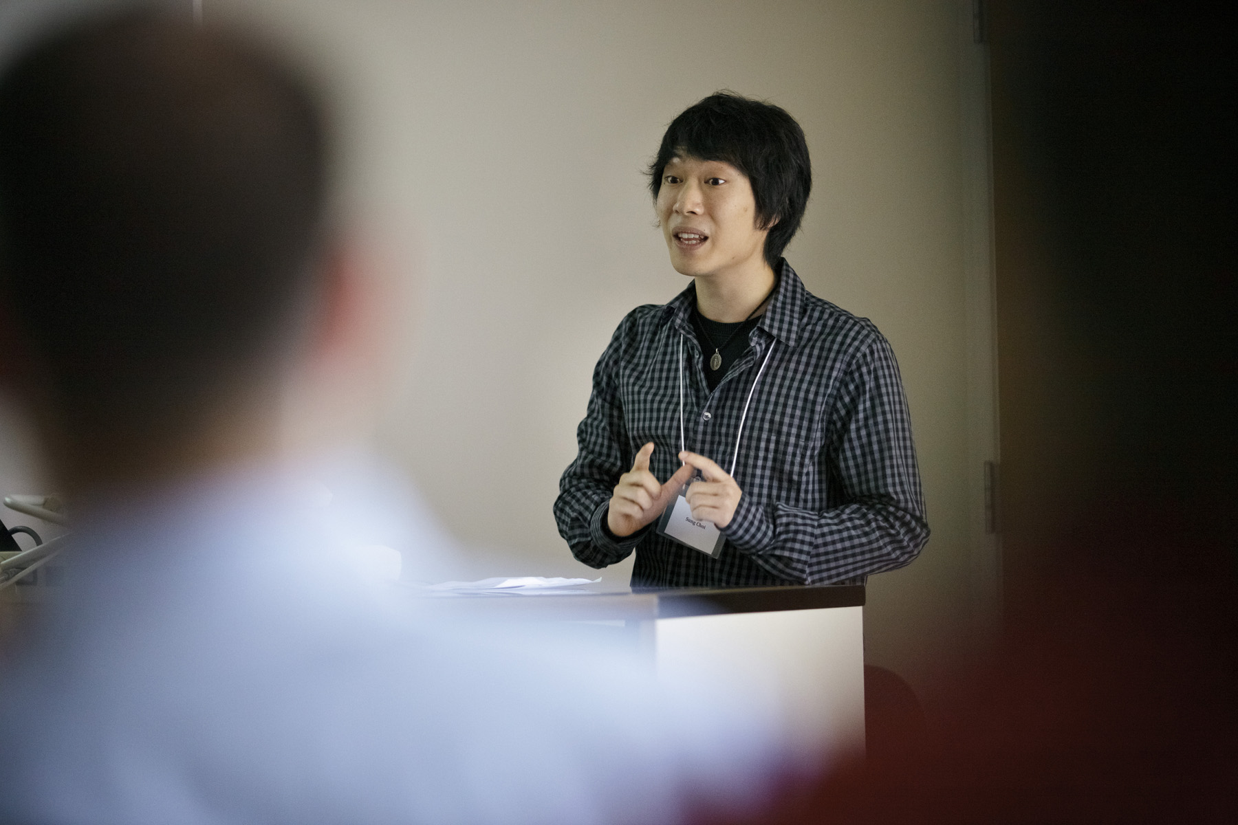 Sung H. Choi presents his research to the group.